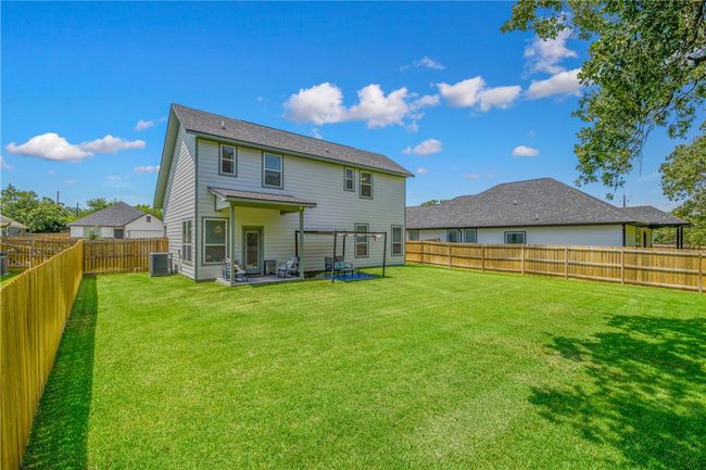 Rear view of property with a fenced backyard and a patio area | Image 28