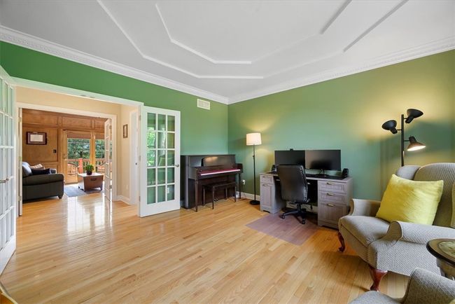 Glass French doors are provided from the living room into the hallway. The den is across the hall. | Image 10