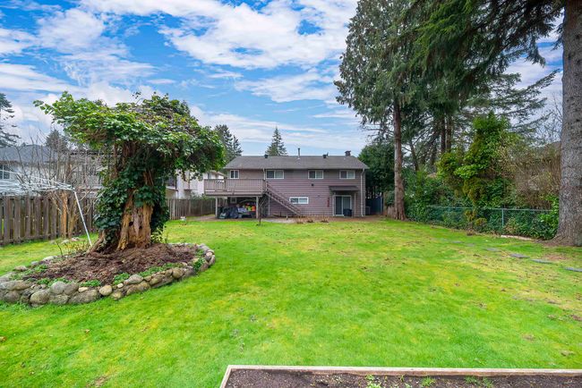 View of yard featuring a fenced backyard, stairs, and a wooden deck | Image 5