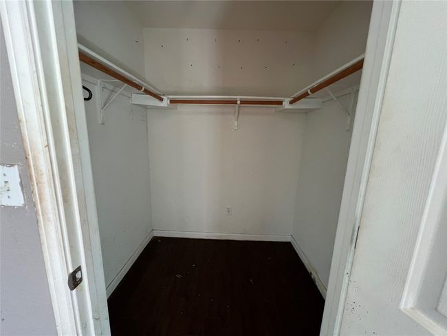 Spacious closet featuring dark wood-style flooring | Image 14
