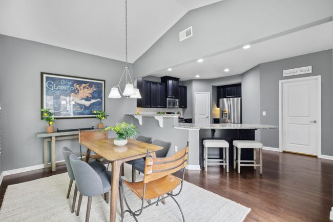 Notice the bartop as well as the countertop seating in addition to the dining table area | Image 13