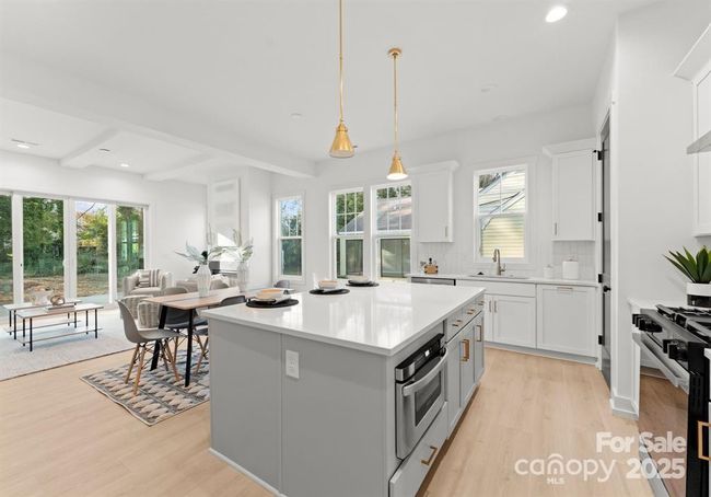 Bright and airy living room with 10 ft ceilings, large windows, and a bi-fold sliding glass door that floods the space with natural lights. | Image 11