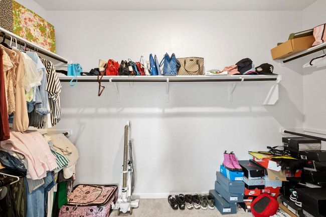 Walk in closet featuring carpet floors | Image 15