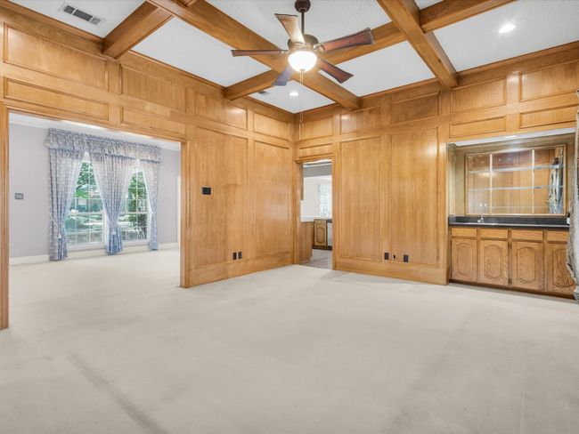 Den opens to both the living room and kitchen for easy access to both spaces. | Image 13