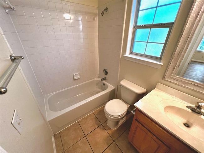 Full bathroom with shower / tub combination, vanity, and tile patterned flooring | Image 12