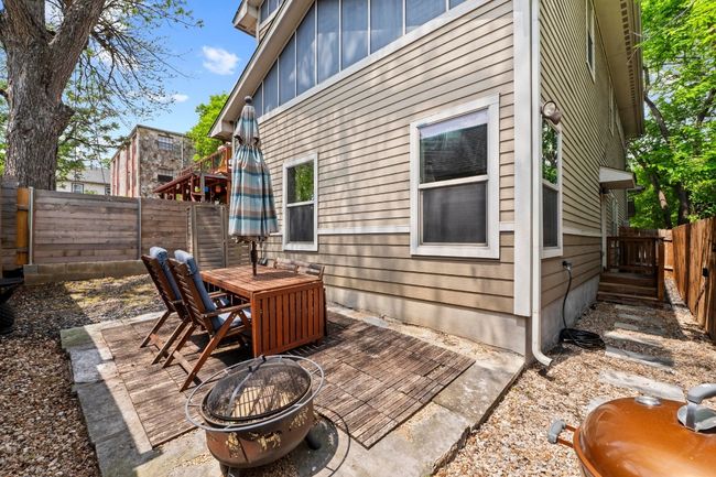View of patio / terrace with an outdoor fire pit, a fenced backyard, and outdoor dining area | Image 25