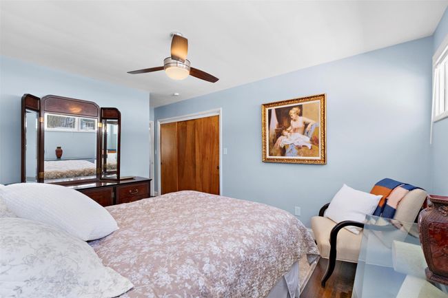 Bedroom with a closet, ceiling fan, and wood finished floors | Image 26