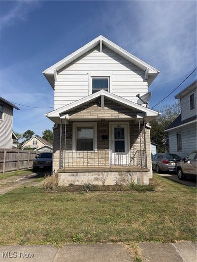 View of front of house with a porch and a front yard | Image 1