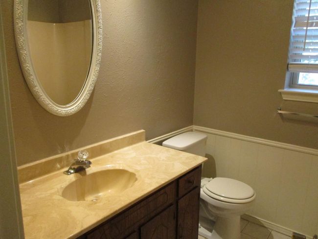Bathroom with vanity, toilet, wainscoting, tile patterned flooring | Image 12