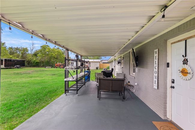 View of patio featuring outdoor lounge area | Image 29