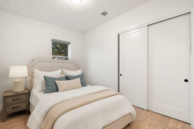 Bedroom with light wood-type flooring and a closet | Image 24