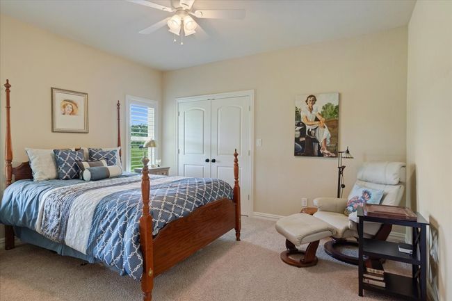 Bedroom featuring light carpet, a closet, baseboards, and a ceiling fan | Image 16