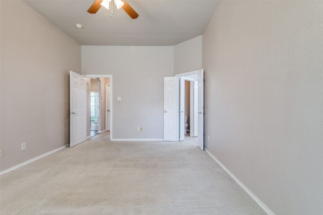 Unfurnished bedroom featuring light carpet and a ceiling fan | Image 21