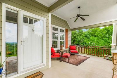 View of exterior entry with a balcony and ceiling fan | Image 2