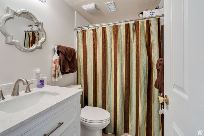 Full bathroom with vanity and curtained shower | Image 15