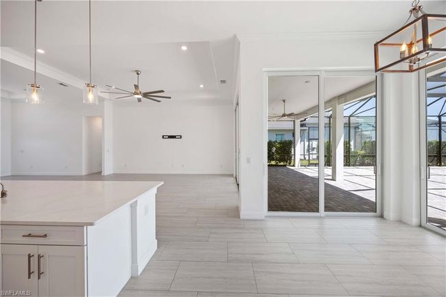 Kitchen featuring open floor plan, ornamental molding, and ceiling fan | Image 12
