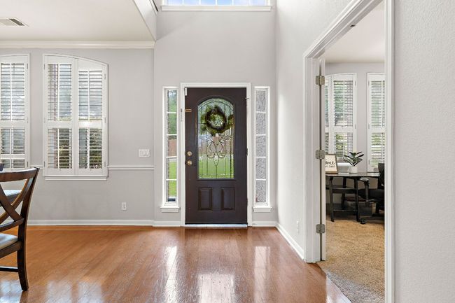 Foyer view with wood floors that open into the dining room and bedroom/office/flex space. | Image 5