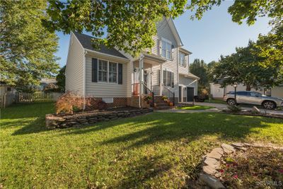 View of front facade with a front yard | Image 3