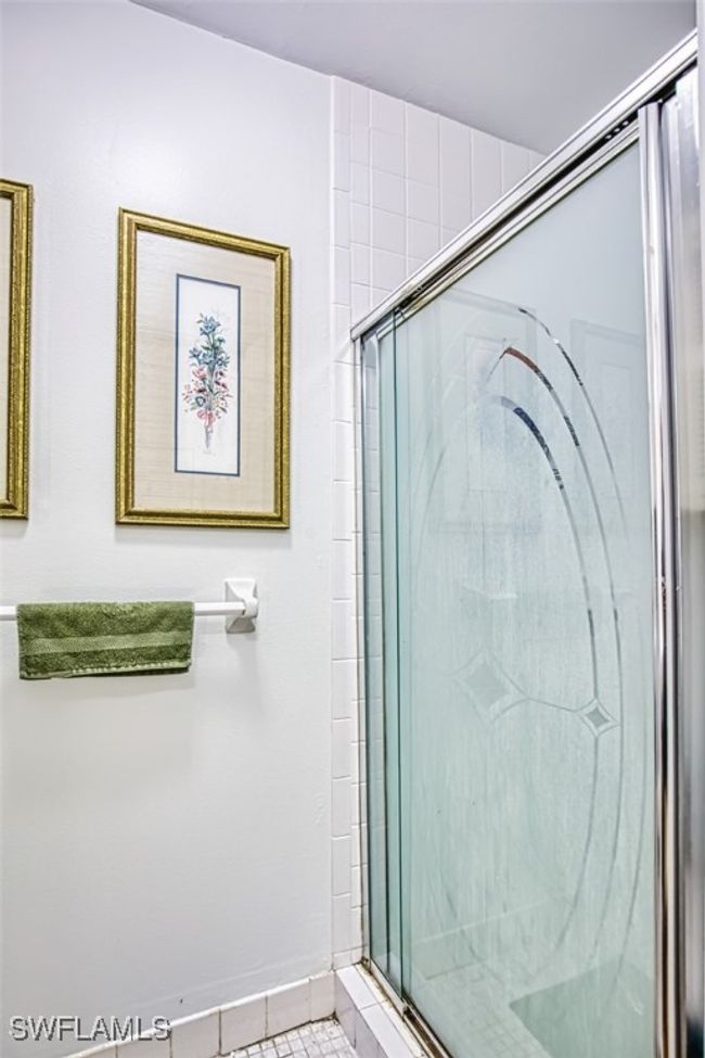 Bathroom featuring a shower stall and tile patterned flooring | Image 23