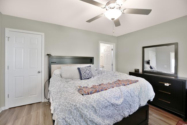 Bedroom featuring wood finished floors and ceiling fan | Image 20