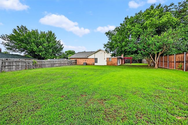 View of fenced backyard | Image 19