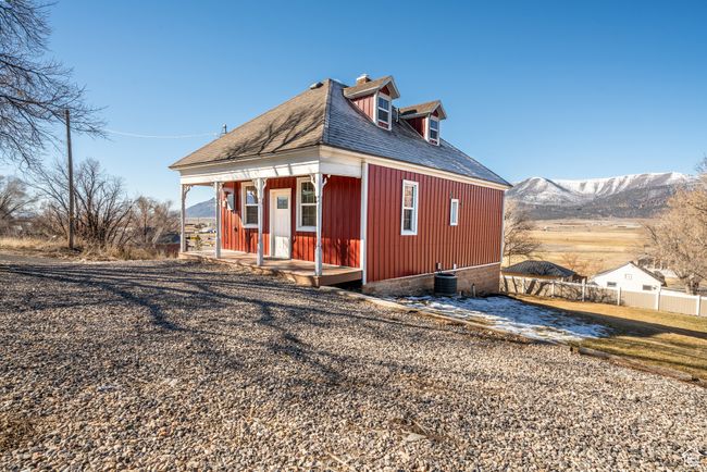 View of side of property with a shingled roof, fence, and a mountain view | Image 34