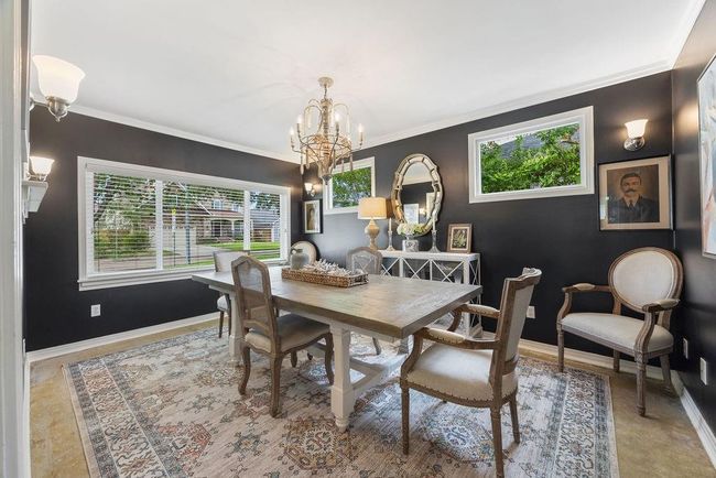The dining room is spacious and bright. Pictured here is an 8 foot long table. | Image 7