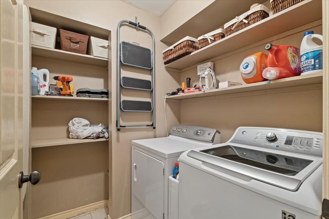 Laundry room with washing machine and clothes dryer and tile patterned flooring | Image 28