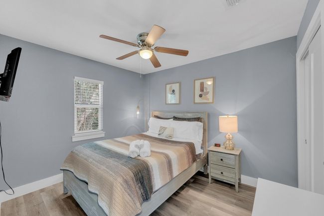 Bedroom featuring baseboards, a closet, light wood-style floors, and ceiling fan | Image 20
