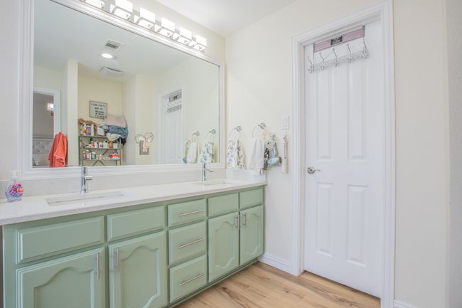 Bathroom featuring wood finished floors, a sink, visible vents, and double vanity | Image 13