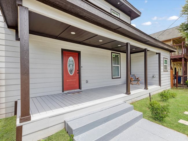 Doorway to property with covered porch and a lawn | Image 6