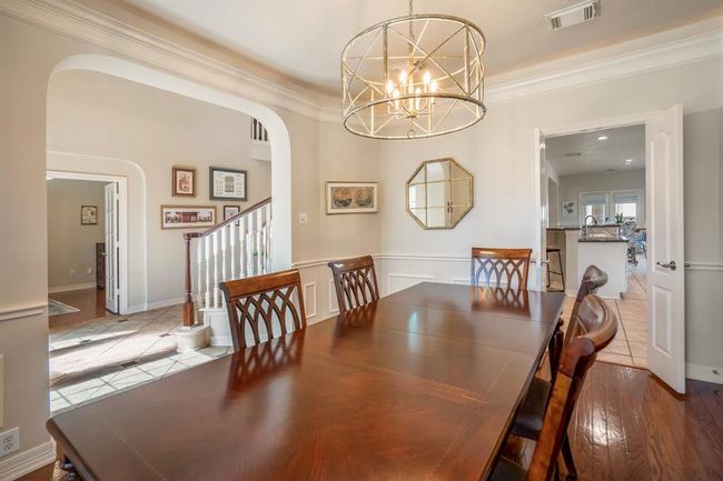 A highlight of this home is the architectural arches which elevate the home from the minute you walk in. Double doors to the kitchen area are on the opposite end. | Image 10