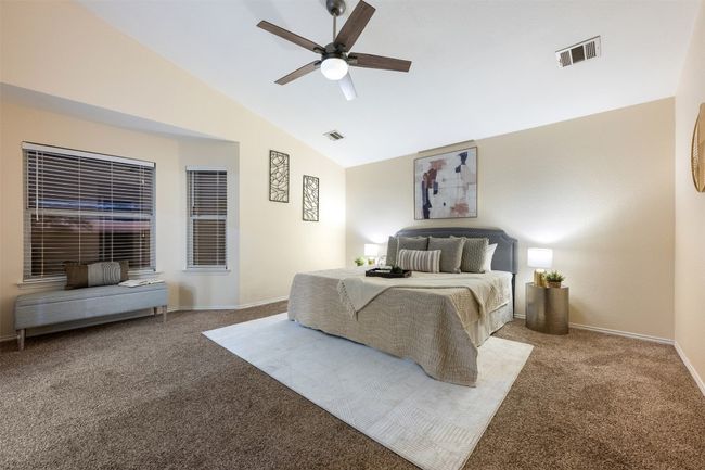 Bedroom featuring baseboards, vaulted ceiling, carpet flooring, visible vents, and ceiling fan | Image 21