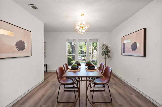 Formal dining area includes modern, decorative chandelier! | Image 19