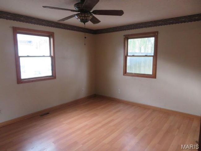 Empty room with ceiling fan, a healthy amount of sunlight, and light hardwood / wood-style floors | Image 15