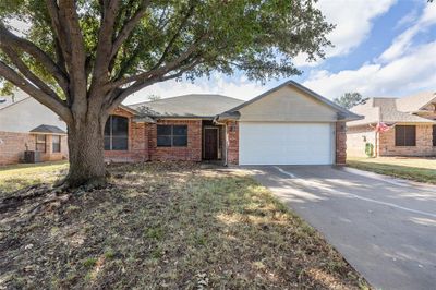 Single story home with a garage and central AC unit | Image 3