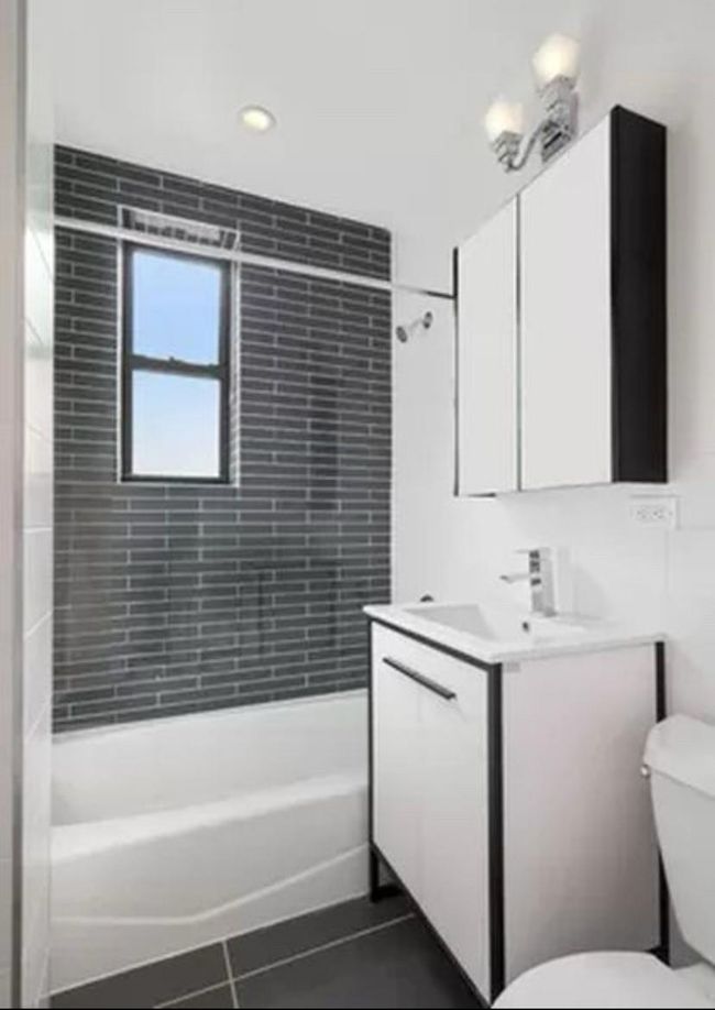 Bathroom with toilet, vanity, tile patterned floors, and shower / bathing tub combination | Image 4