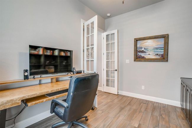 Office area with wood finished floors, built in desk, and french doors | Image 35