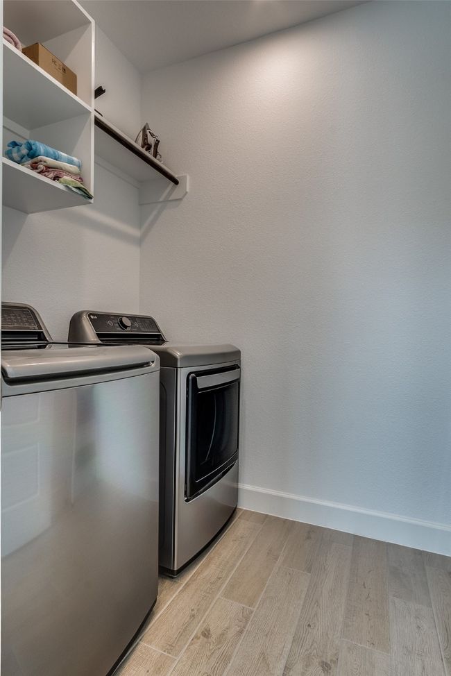 Washroom featuring independent washer and dryer and light wood-type flooring | Image 25