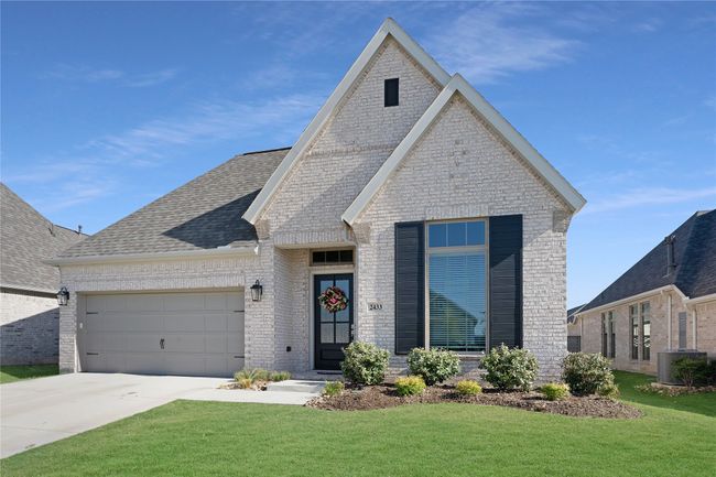View of front of house featuring brick siding, a front lawn, an attached garage, concrete driveway, and roof with shingles | Image 23