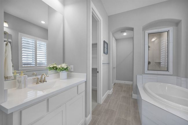 Primary Full Bathroom with double vanity, standing shower, and a garden tub. | Image 19