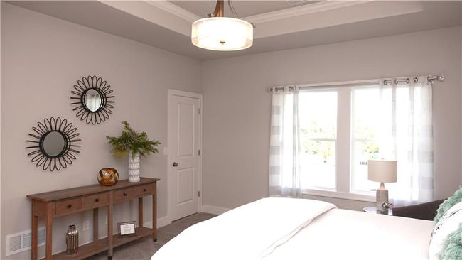 Carpeted bedroom with baseboards, visible vents, and ornamental molding | Image 35