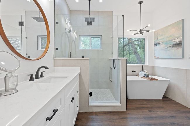 Full bathroom featuring dual vanity, recessed lighting, a freestanding tub, and a walk-in shower | Image 27