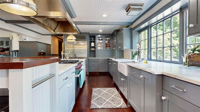 Kitchen with Wolf Range, dual dishwashers on either side of farmers sink | Image 8