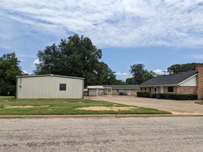 View of front of house with driveway, a front yard, and an outbuilding | Image 9