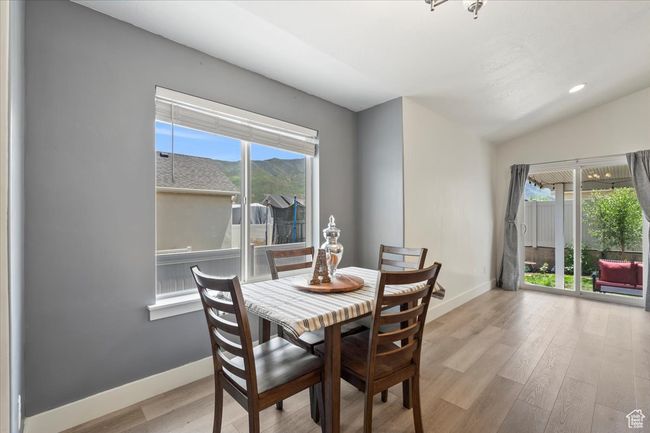 Dining area featuring baseboards, wood finished floors, and vaulted ceiling | Image 13