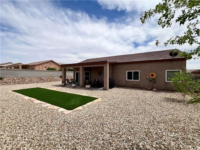 Rear view of property featuring fence, a patio, and stucco siding | Image 43