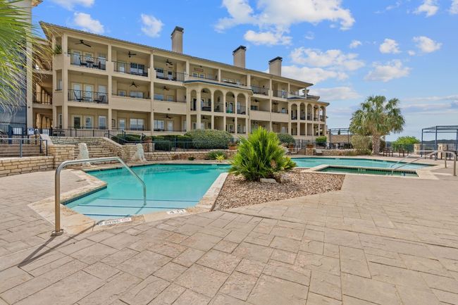 Lakefront living, 1 of 2 pools and jacuzzi areas adjacent to the beautiful Lake Travis. | Image 13