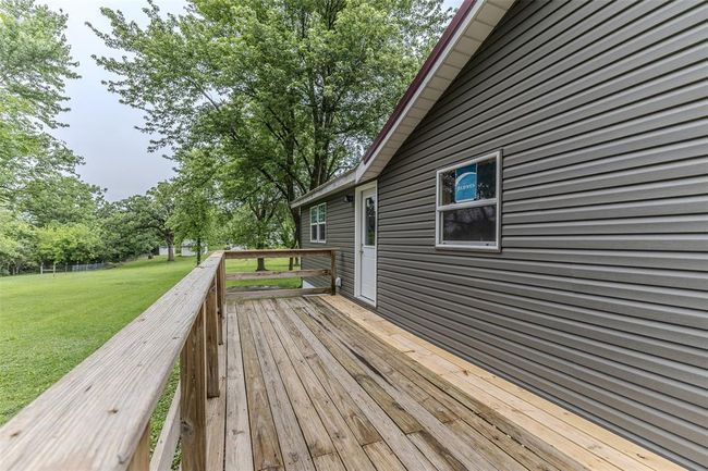 Wooden deck featuring a lawn | Image 41