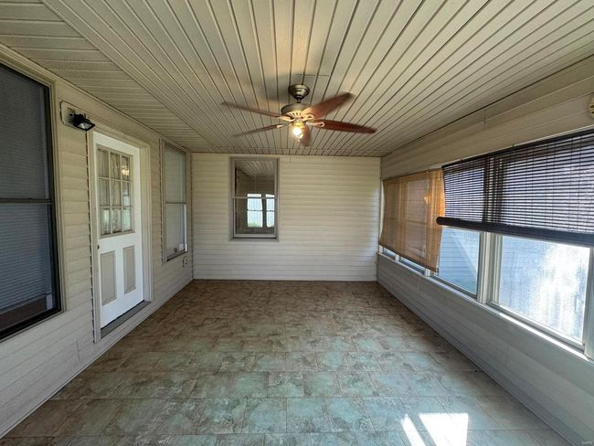 Unfurnished sunroom with wood ceiling and ceiling fan | Image 16
